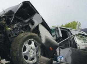 Car collides with concrete wall, injuring driver