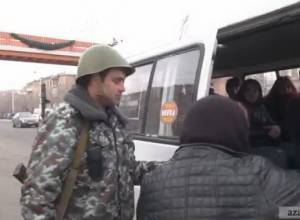 Armed police officers searching vehicles in Yerevan 