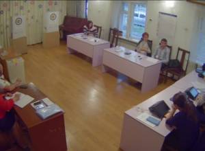 Electoral officials sit inside empty polling stations in Yerevan