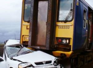 Electric train clashes with automobile