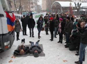 Protesters lie in front of vehicle to ban its move
