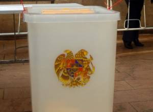 Election violation: Man sitting by ballot box