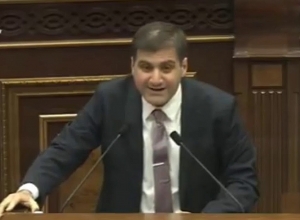 What is the reason that Yolyan continues to serve a year after the revolution? A. Babajanyan