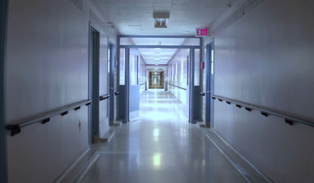 pan-down-to-roll-down-hospital-hallway-empty-white-walls_bgetwtyzl_thumbnail-full08
