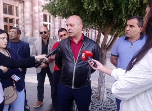 Group of officers gather in front of Government building